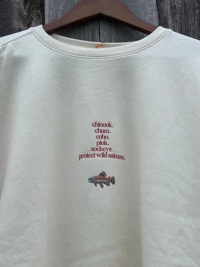 Cream crew neck sweater with multi indigenous salmon design and text in maroon with the saying ‘respect the logo’ in the centre of front. A nature, sustainable designed sweater featuring different salmon species stacked and indigenous salmon design on back. 