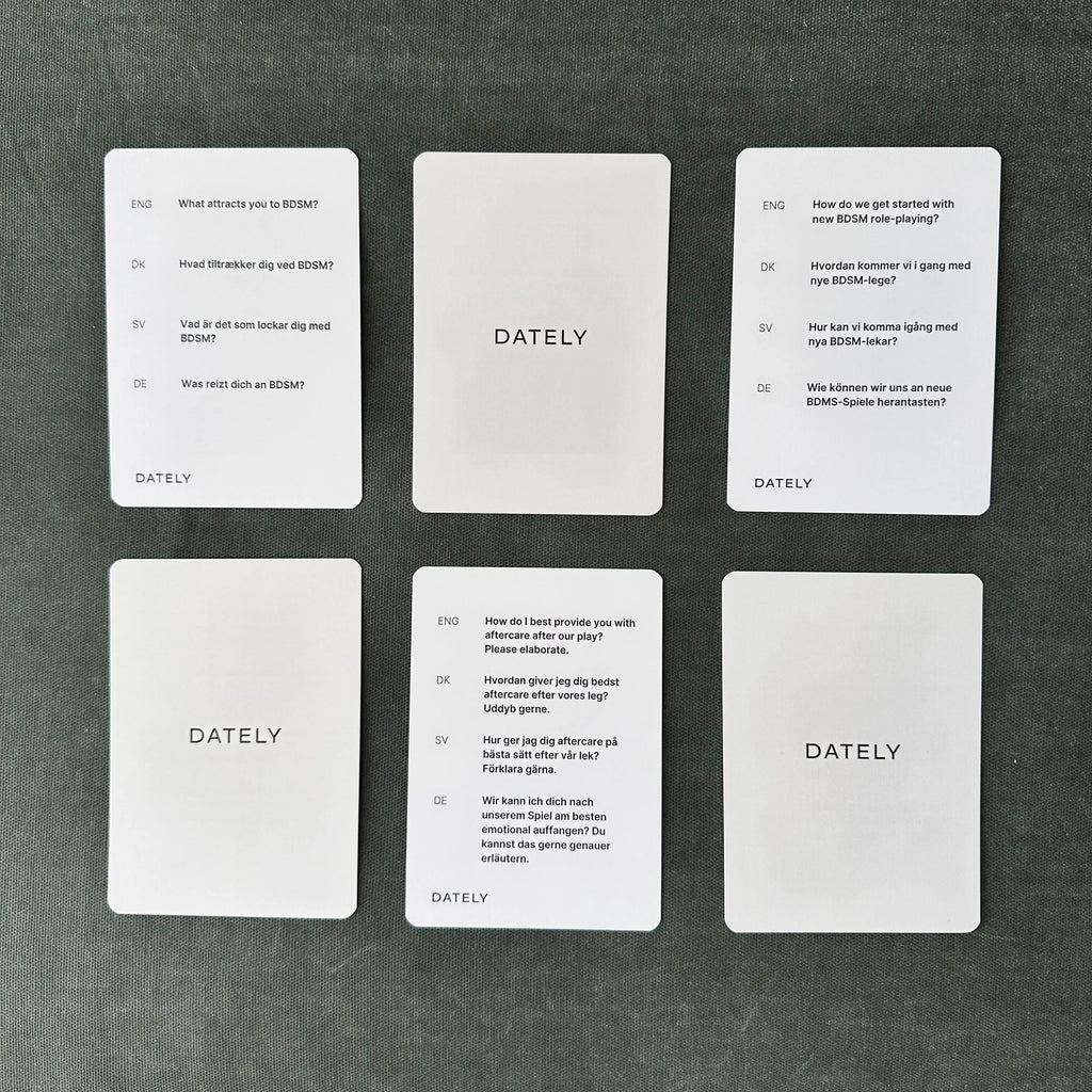 BDSM conversation cards by Dately displayed laying face up. Featuring 52 conversation prompts to safely and openly discuss power play, BDSM and intimacy in your relationship leading to stronger connection and understanding. Available in multiple languages with cardboard packaging. 