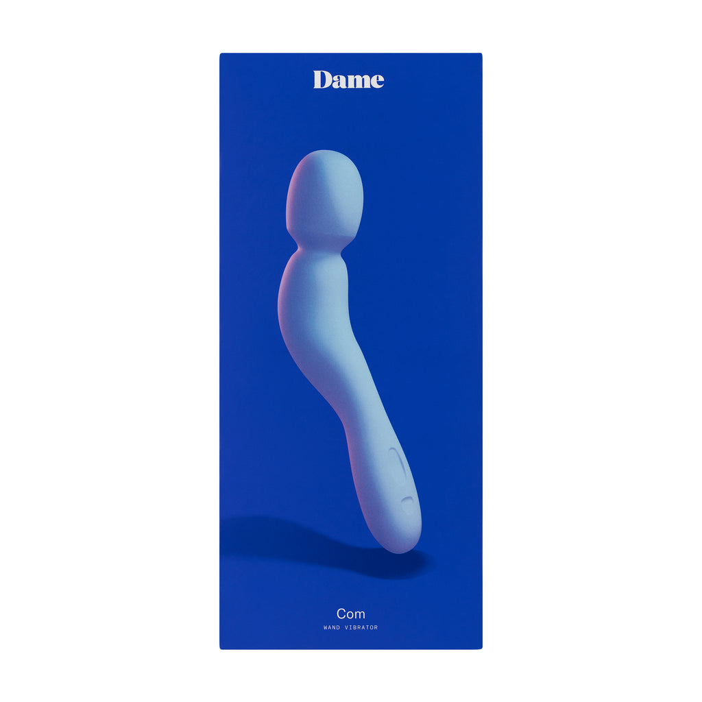 Dark blue box of Dames Com wand vibrator in colour periwinkle displayed against solid white background. 