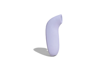 Lavender coloured AER by dame, suction stimulator displayed side facing on solid white background.