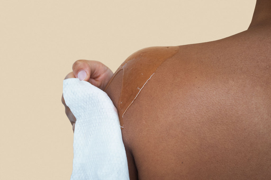 Close up image of Dames body wipe being used while an individuals wipes their shoulder. 