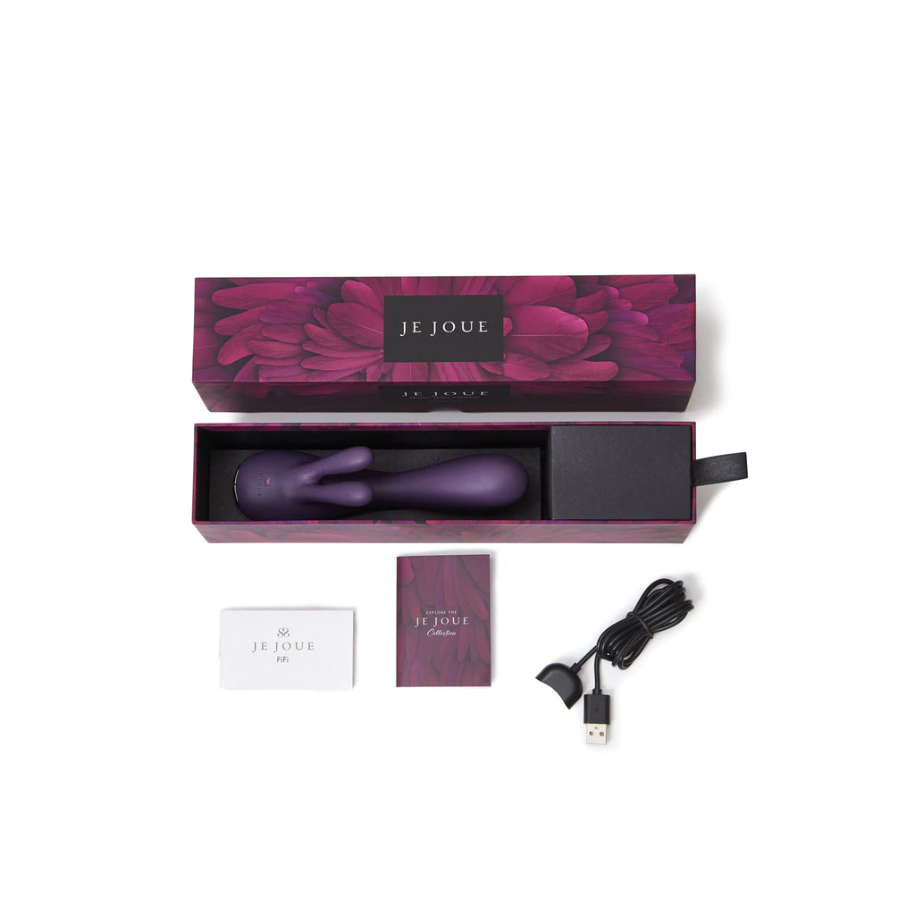 Contents of Je Joue rabbit vibrator in deep purple in product box with contents displayed around. Includes vibrator, charging cable and instruction manuals laid on solid white background. 