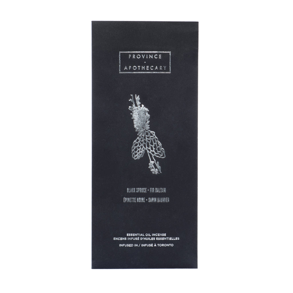 Black foil decorated package of Provice apothecary incense in black spruce and fir balsam, displayed standing against white background.