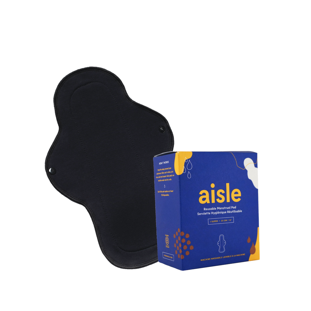 Blue decorated box of Aisle super absorbency reusable menstrual pad in front of black cotton pad with snap enclosures in front of white background.