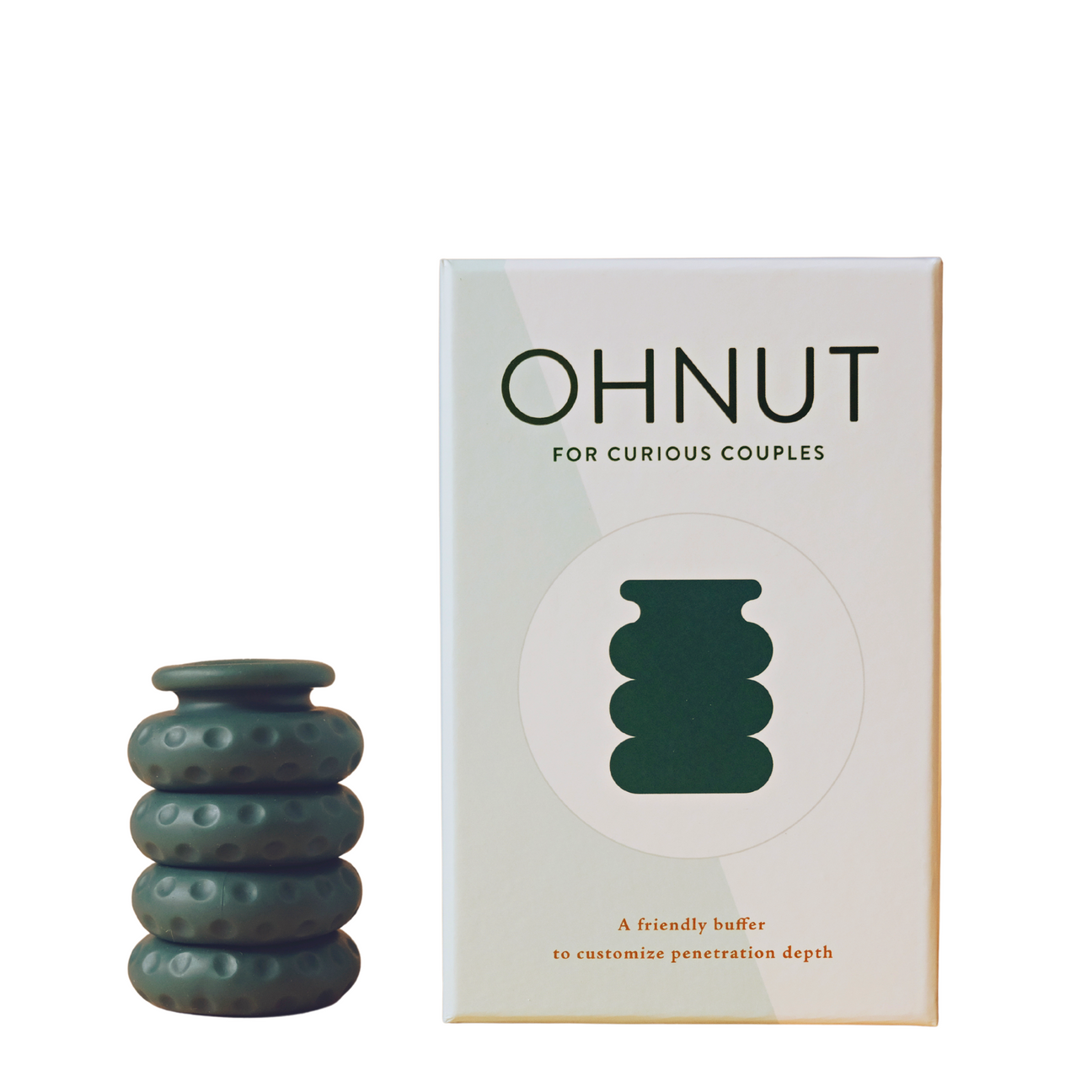 Oh Nut brand silicon intimate wellness buffer in the colour aloe, being displayed beside products box against dark nude background