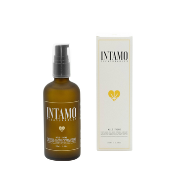 glass brown bottle of intamo wild thing personal lubricant by Intamo. Product is displayed with white box to the right centered in the middle of solid white background.