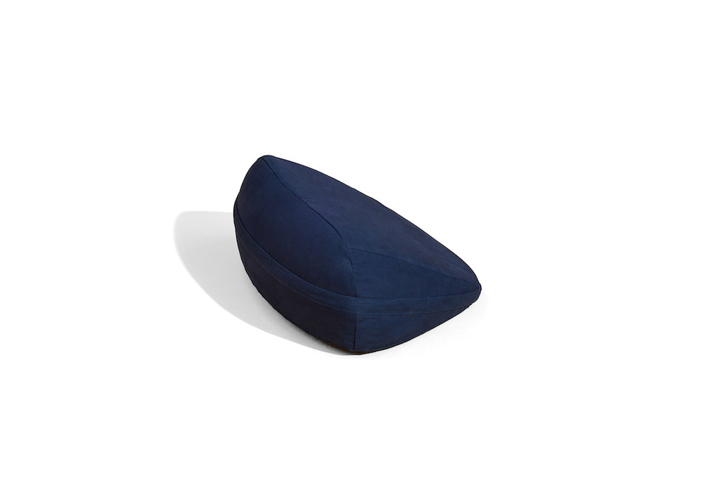 Dark blue wedge shaped pillow by Dame displayed on white background. Pillo is a sexual wellness pillow designed to increase pleasure, make  positions more comfortable and accessible during sex and intimate moments. 